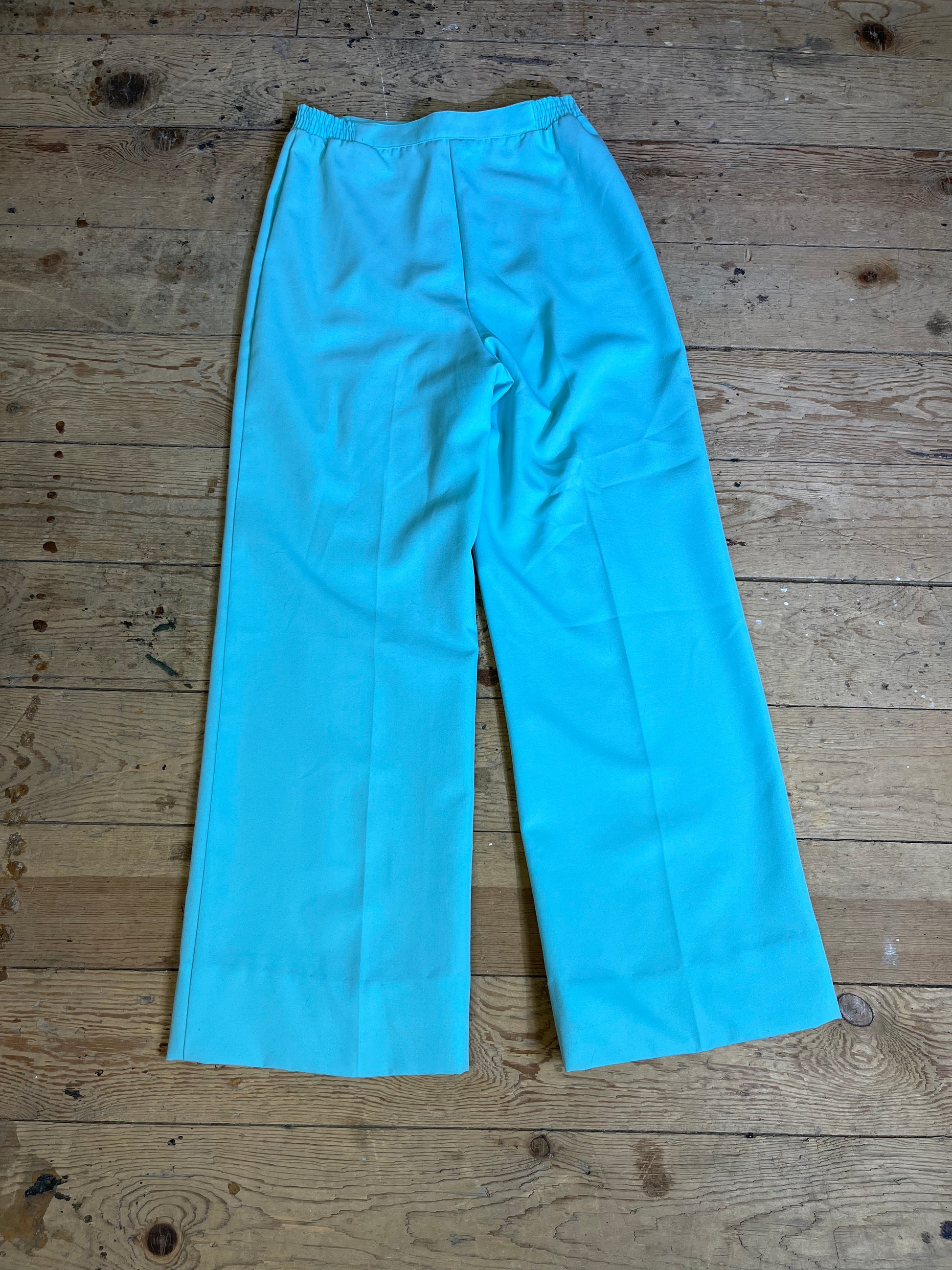 1970s High Rise Seafoam Teal Trousers - Back View: Discover sophistication in every detail. Back view showcasing the high-rise silhouette and classic design with a hint of seafoam teal allure