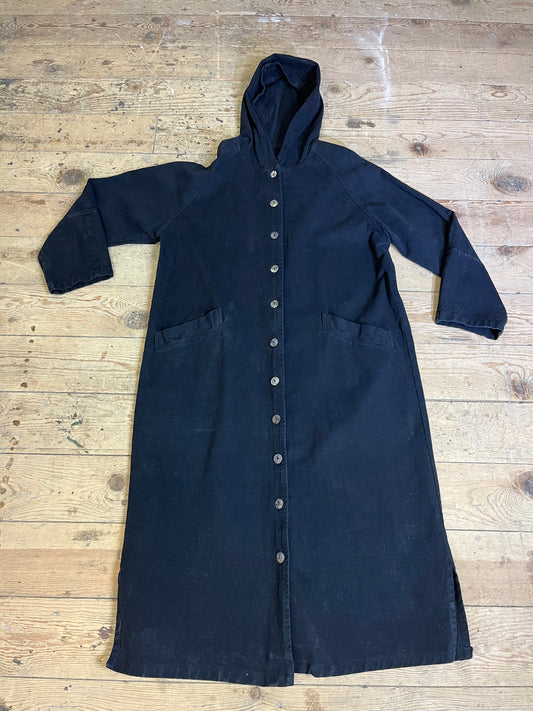 "Front view of Vintage Black Trench Coat by Color me Cotton. Classic button-up design with a stylish hood, showcasing timeless elegance."