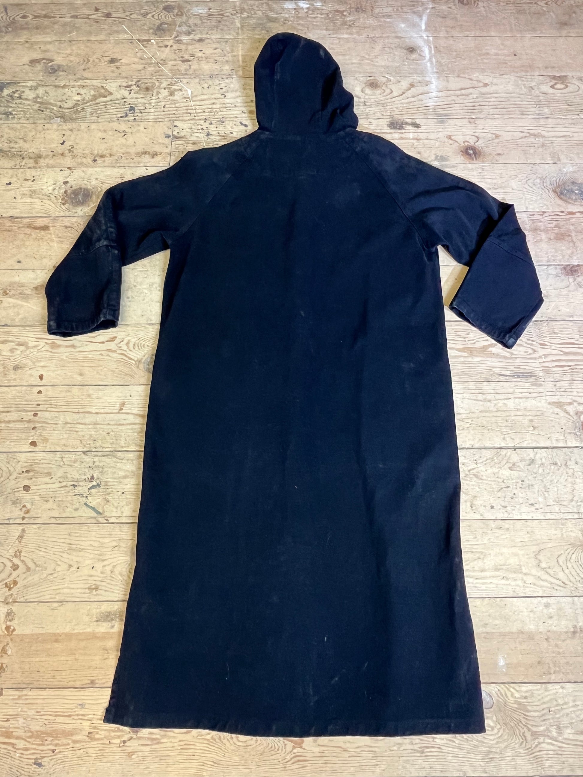  "Rear view of Vintage Black Trench Coat with hood by Color me Cotton. Elegant design featuring a stylish hood, showcasing timeless sophistication."