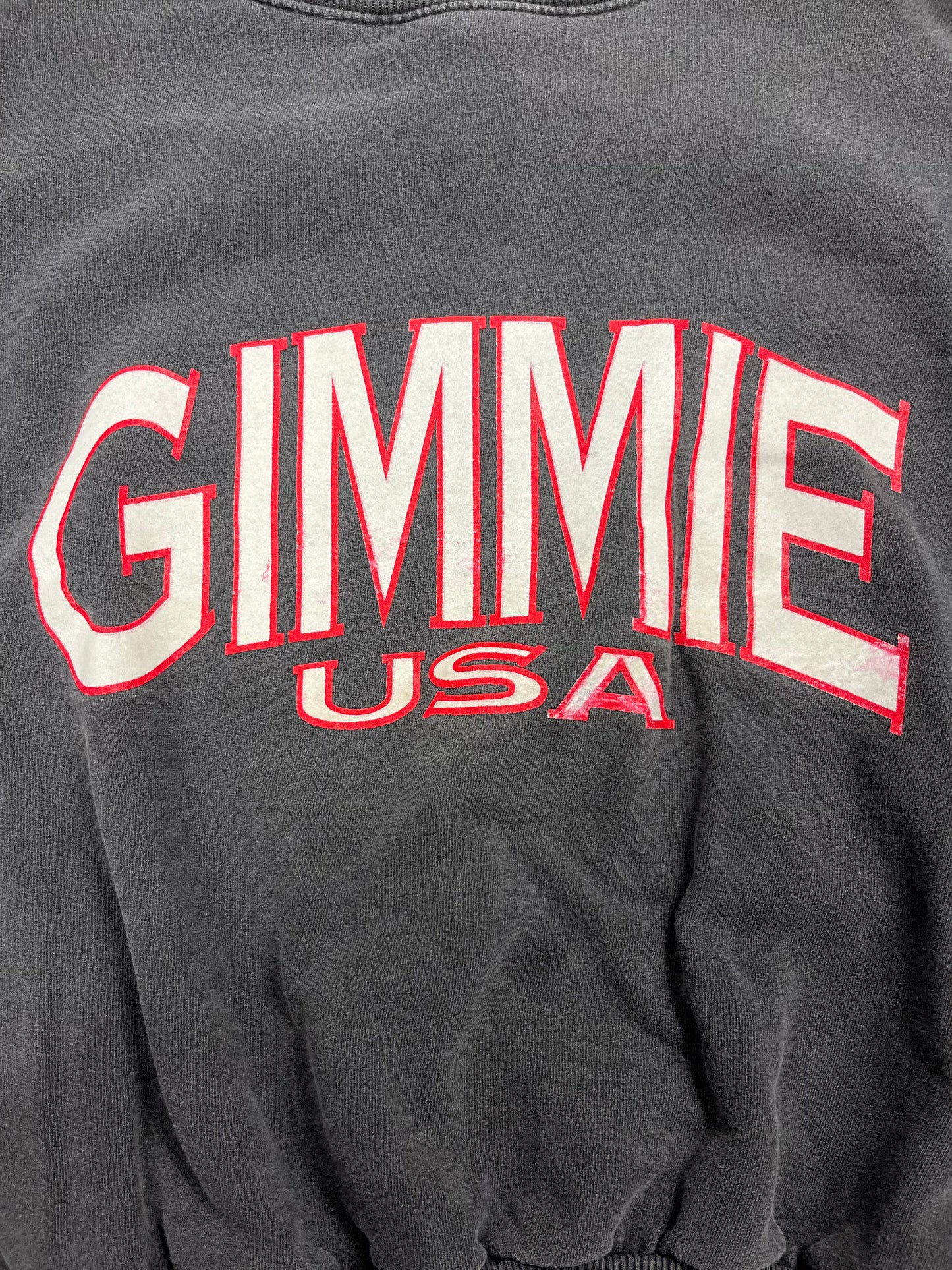 Close-up of Gimmie USA Logo on '90s Vintage Sweatshirt. Unisex, Made in USA, 100% Cotton. Quality craftsmanship in every detail. Shop the logo vibe!