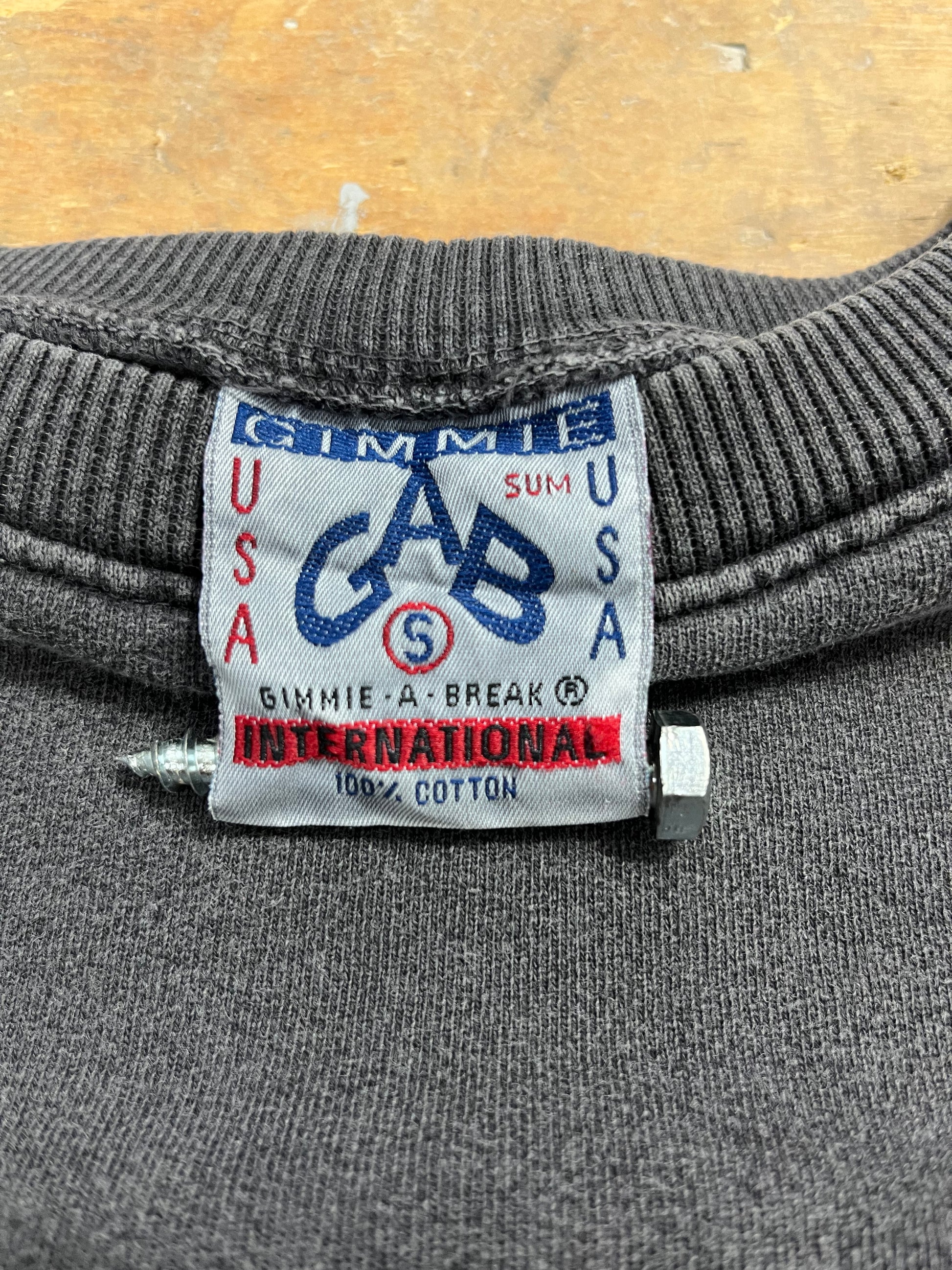 Tagged: '90s Vintage Sweatshirt by Gimmie USA. Unisex, Made in USA, 100% Cotton. Elevate your style with this timeless piece. Gimmie-a-break.