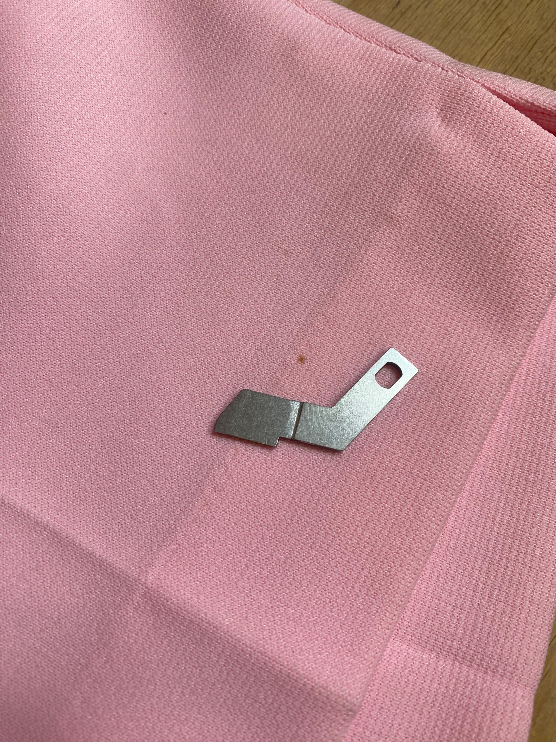 "Image revealing a small stain on Vintage High-Waisted Pink Shorts by Haymaker Lacoste, providing an honest portrayal of the product's condition."