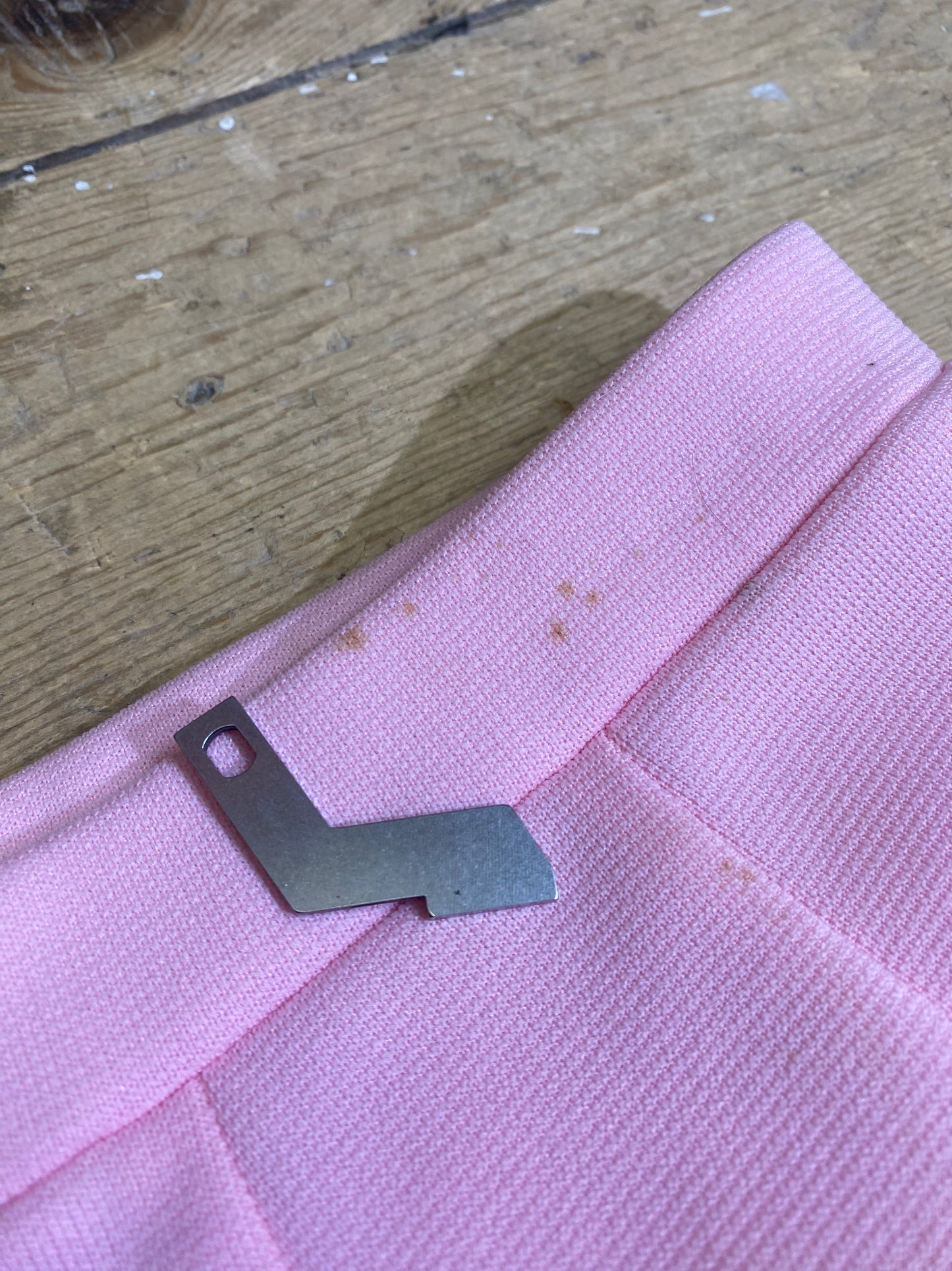 "Detail shot of imperfections on Vintage High-Waisted Pink Shorts by Haymaker Lacoste, showcasing authenticity and uniqueness in the garment's character."